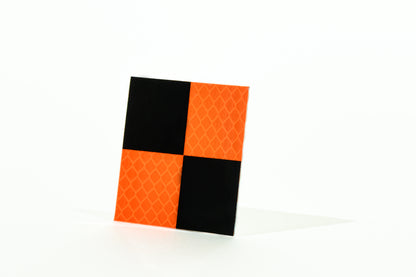 <transcy>Orange and black reflective target</transcy>