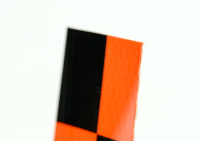 <transcy>Orange and black reflective target</transcy>